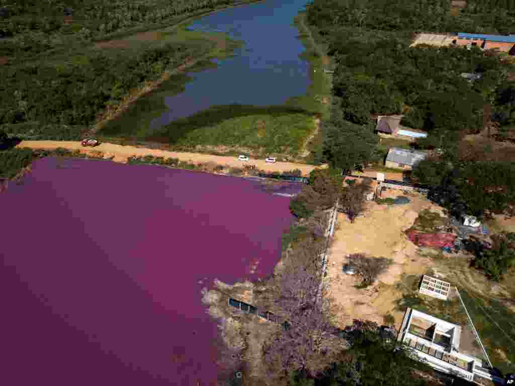 A road divides the Cerro Lagoon and the Waltrading S.A. tannery, bottom right, in Limpio, Paraguay, Aug. 5, 2020.&#160;According to the National University Multidisciplinary Lab, the color of the water is due to the presence of heavy metals like chromium.