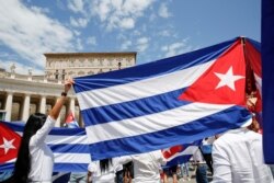 Cuban community hold flags of Cuba during the Angelus prayer led by Pope Francis, in St Peter's Square at the Vatican, July 18, 2021.