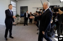 U.S. Vice President Mike Pence, right, heads to shake hands with Argentina's President Mauricio Macri at the government residence in Buenos Aires, Argentina, Aug. 15, 2017. Pence is on a official visit to Argentina until Wednesday.