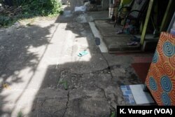 Tiles end abruptly where residents had to shave five meters off the fronts of their homes in Kampung Tongkol, Indonesia.