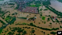 An aerial view shows flooding caused by heavy rains in Itapetinga, Bahia state, Brazil, Dec. 26, 2021.