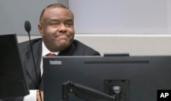 FILE - Jean-Pierre Bemba takes his seat in the court room of the International Criminal Court in The Hague, Netherlands, March 21, 2016.