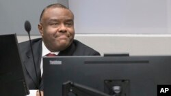 FILE - Jean-Pierre Bemba takes his seat in the courtroom of the International Criminal Court in The Hague, Netherlands, March 21, 2016. 