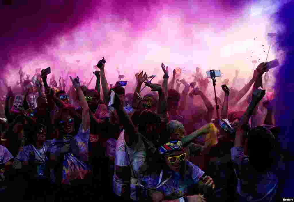 Colored powder is sprayed on runners as they celebrate during a &quot;Color Fun Run&quot; in Pasay city, Metro Manila, Philippines.