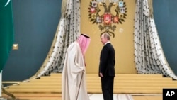 Russian President Vladimir Putin, right, talks with Saudi King Salman during their meeting in the Kremlin, Moscow, Russia, Thursday, Oct. 5, 2017.