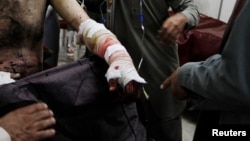 A man injured in a bomb blast during an election campaign rally of the Jamiat Ulema-e-Islam religious party at Kurram agency, sits at a hospital in Peshawar May 6, 2013.