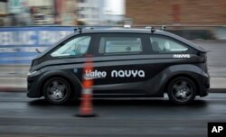 A Navya Autonom Cab, a self-driving vehicle, drives down a street during a demonstration at CES International, in Las Vegas, Nevada, Jan. 8, 2018.