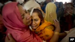 Pakistani Christian women mourn the deaths of their family members during a funeral service at a local church in Lahore, Pakistan, March 28, 2016. 