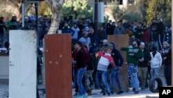 Palestinians clash with Israeli troops during a protest against U.S. President Donald Trump's decision to recognize Jerusalem as the capital of Israel in the West Bank City of Nablus, Dec. 8, 2017.