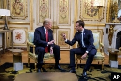 President Donald Trump, left, meets with French President Emmanuel Macron inside the Elysee Palace in Paris, Nov. 10, 2018. Trump is joining other world leaders at centennial commemorations in Paris this weekend to mark the end of World War I.