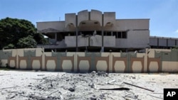 A picture taken during a government-guided tour on May 12, 2011 shows a damaged building in Bab al-Aziziya in Tripoli, following NATO air strikes on Libyan leader Moamer Gadhafi's compound