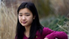 High school student Grace Hu, 16, sits for a photograph near Sharon High School, Sunday, April 11, 2021, in Sharon, MA.