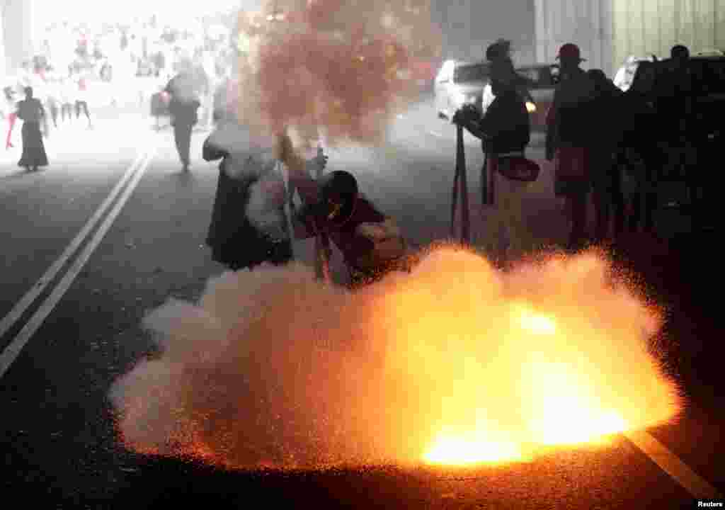 A Mexican fires a homemade shotgun during a re-enactment of the battle of Puebla, along the streets in the Penon de los Banos neighbourhood of Mexico City, Mexico, May 5, 2018.