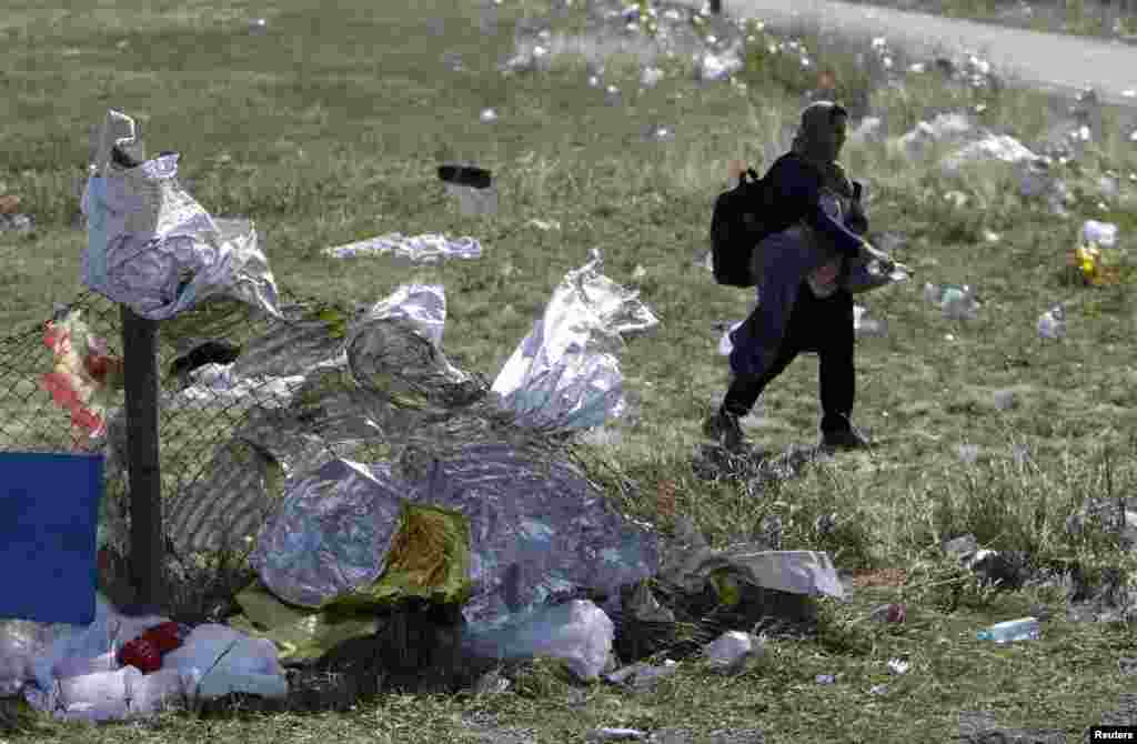 A migrant passes first aid blankets at the Austria-Hungaria border, walking towards Nickelsdorf, Austria.