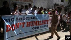 A police officer stops a group of Indians protesting against the arrest of Devyani Khobragade, an Indian consular officer in New York, outside the U.S consulate in Hyderabad, India, Dec. 16, 2013.