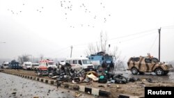 Indian soldiers examine the debris after an explosion in Lethpora in south Kashmir's Pulwama district, Feb. 14, 2019.
