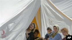 Syrian refugees are seen in a camp, in Boynuyogun, Turkey, Tuesday, June 14, 2011.