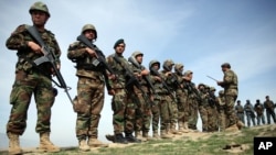 FILE - Afghan National Army soldiers stand in formation following weeks of heavy clashes with Taliban fighters in Dahna-e-Ghori district, Baghlan province, Afghanistan, Mar. 15, 2016.