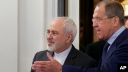 Russian Foreign Minister Sergey Lavrov, right, welcomes his Iranian counterpart, Mohammad Javad Zarif, at their meeting in Moscow, Russia, Aug. 17, 2015. 
