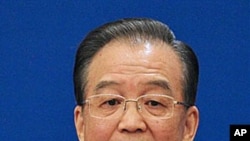 Chinese Premier Wen Jiabao gestures as he answers questions during a press conference after the closing session of the annual National People's Congress in Beijing's Great Hall of the People Monday, March 14, 2011.