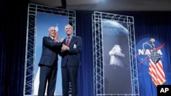 Vice President Mike Pence, left, is introduced by NASA Administrator Jim Bridenstine during a visit to NASA's Johnson Space Center in Houston, Aug. 23, 2018.