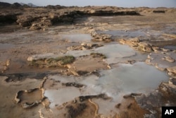 Travertine pools with white films of carbon fused with calcium are shown in the al-Hajjar mountains of Oman, March 5, 2017.