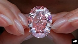 The "Pink Star" diamond, the most valuable cut diamond ever offered at auction, is displayed by a model at a Sotheby's auction room in Hong Kong, March 29, 2017.