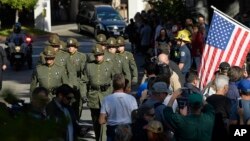 The body of Ventura County Sheriff's Dept. Sgt. Ron Helus is transported from the Los Robles Regional Medical Center, Nov. 8, 2018, in Thousand Oaks, Calif.