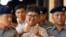 Reuters journalist Wa Lone, center, gives a thumbs up sign as he is escorted by police upon arrival at the court for trial in Yangon, Myanmar Friday, April 20, 2018. 