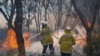 Firemen put out bushfire flames in Red Gully, Western Australia, in this undated handout image. (Evan Collis/Department of Fire and Emergency Services/Handout via Reuters)