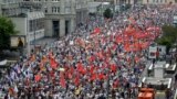 Demonstrators hold the flags of various groups during a massive protest against Putin&#39;s rule in Moscow, Tuesday, June 12, 2012. 