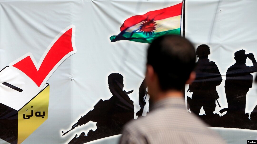 A man looks at a banner supporting the referendum for independence of Kurdistan in Erbil, Iraq, Sept. 24, 2017.