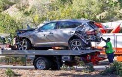 The damaged car of Tiger Woods is towed away after he was involved in a car crash, near Los Angeles, California, Feb. 23, 2021.
