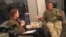 Then-American Forces Network reporter Kane Farabaugh interviews Robin Williams in Afghanistan in 2002.