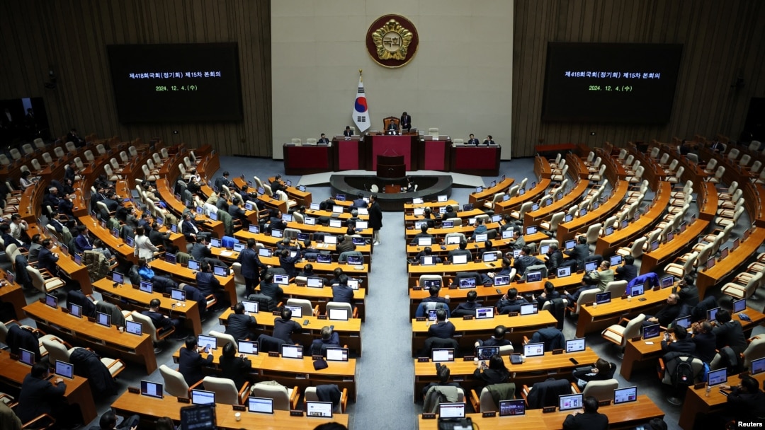 Lawmakers sit inside the hall at the National Assembly, after South Korean President Yoon Suk Yeol declared martial law, in Seoul, South Korea, Dec. 4, 2024.