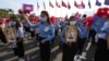 Cambodian students, holding the portrait of King Norodom Sihamoni, participate in the country's 67th Independence Day celebration, in Phnom Penh, Cambodia, Monday, Nov. 9, 2020. (AP Photo/Heng Sinith)