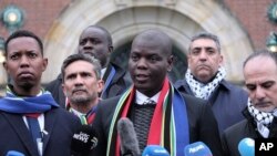 FILE - South Africa's Minister of Justice and Correctional Services Ronald Lamola, center, and Palestinian assistant Minister of Multilateral Affairs Ammar Hijazi, right, address the media outside the International Court of Justice in The Hague, Netherlands, January 11, 2024.