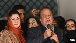 Pakistan's former Prime Minister Nawaz Sharif (C) and leader of the Pakistan Muslim League (PML) party, along with his younger brother and former prime minister Shehbaz Sharif (R) and his daughter Maryam Nawaz (L) speaks with supporters in Lahore on Febru