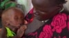 In this photo taken from Video provided by Associated Press on Tuesday, May 13, 2014, a malnourished child is fed by her mother in a Medecins Sans Frontiers (Doctors Without Borders) hospital, in Leer, South Sudan. 