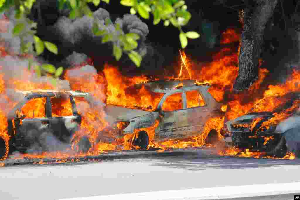 Cars burn after a powerful car bomb in Mogadishu, Somalia, April 17, 2019.