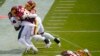 Washington Football Team defensive end Montez Sweat (90) falls while tearing a piece of of Philadelphia Eagles running back Jason Huntley&#39;s jersey who is being tackled by Washington Football Team strong safety Landon Collins (26) and cornerback Jimmy Moreland (20) during the first half of an NFL football game, Sept. 13, 2020, in Landover, Maryland.&nbsp;