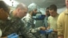 Major Kamal Kalsi works on a patient at Camp Dwyer in Helmand province, Afghanistan, 2011. (Photo courtesy of Major Kalsi)