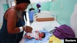 A Haitian mother tends to her baby after giving birth at a local hospital, in Santo Domingo, Dominican Republic Jan. 17, 2025. 