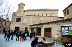 FILE - Children stand near the "El Transito" synagogue and Sephardic Museum in Toledo, Spain, Feb. 27, 2014.