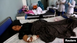 An Afghan woman receives treatment at a hospital after she was injured during an airstrike in Herat province, Afghanistan, Aug. 29, 2017.
