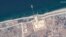 FILE—This image released by Maxa Technologies shows the overview of the new pier off Gaza and aid trucks on May 18, 2024. 