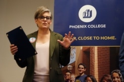 FILE - Arizona Secretary of State Katie Hobbs talks about voter registration at Phoenix College on National Voter Registration Day in Phoenix, Sept. 24, 2019.