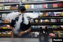 An employee vapes at a vape shop in Jakarta, Indonesia. (Reuters)