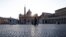 Police officers patrol an empty St. Peter's Square at the Vatican, Friday, April 10, 2020. Pope Francis began the Good Friday service at the Vatican with the Passion of Christ Mass and hours later will preside over the traditional Way of the Cross…