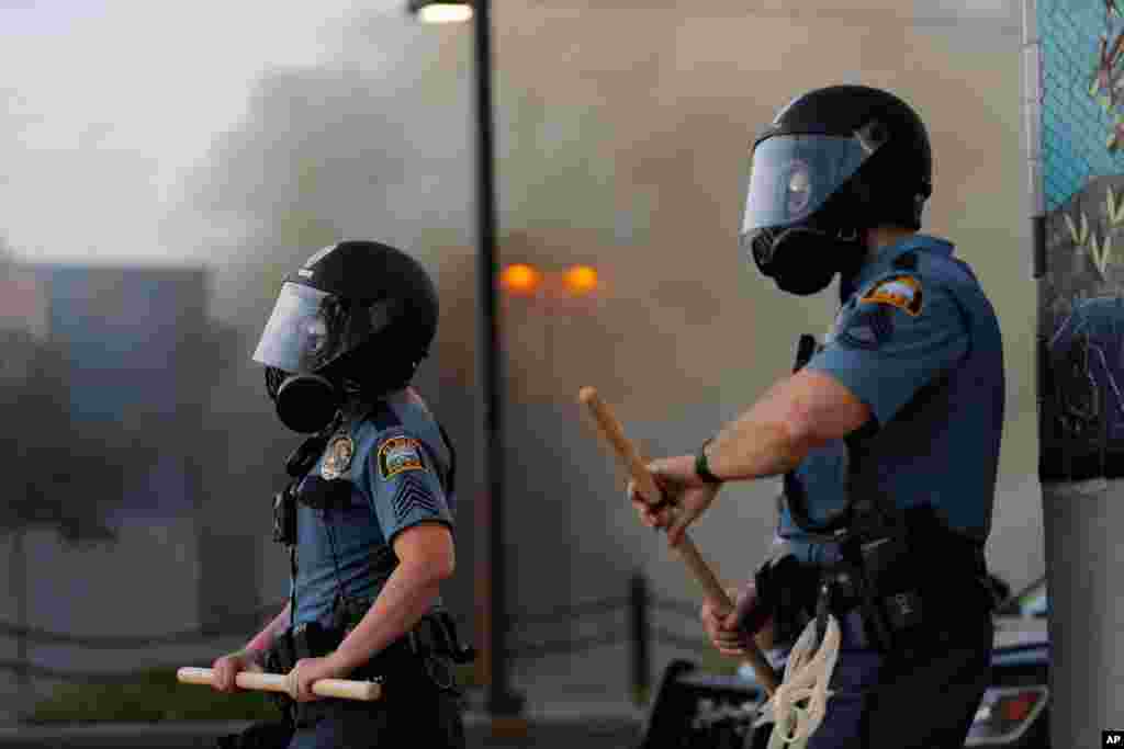 St. Paul police watch demonstrators, May 28, 2020, in St. Paul, Minn. 